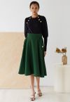 Falda midi evasé con textura gofrada en verde oscuro