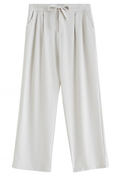 Pantalones con detalles plisados en la cintura con cordón en marfil