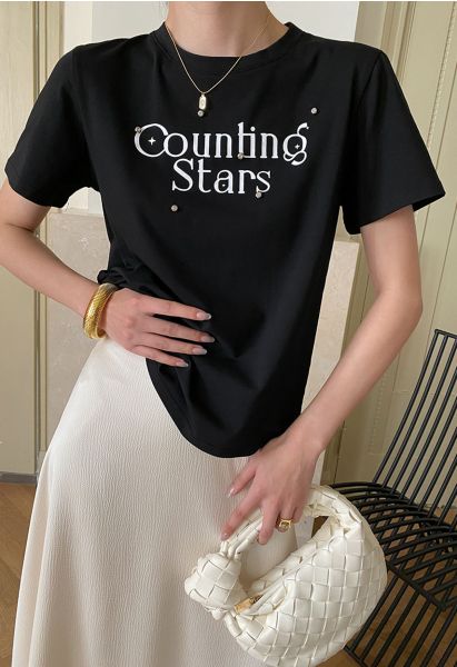Camiseta negra con cuello redondo y estampado de estrellas de Counting