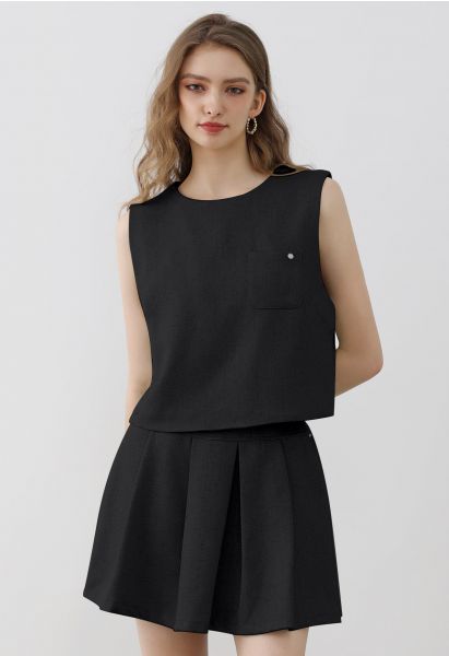 Conjunto elegante de top sin mangas de tweed y minifalda plisada en negro