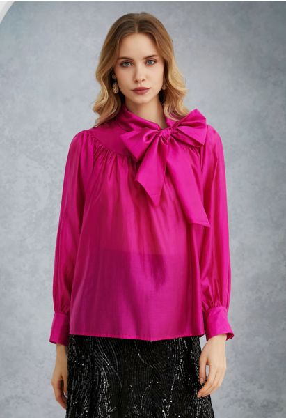 Encantadora camisa transparente con mangas abullonadas y lazo en rosa fuerte