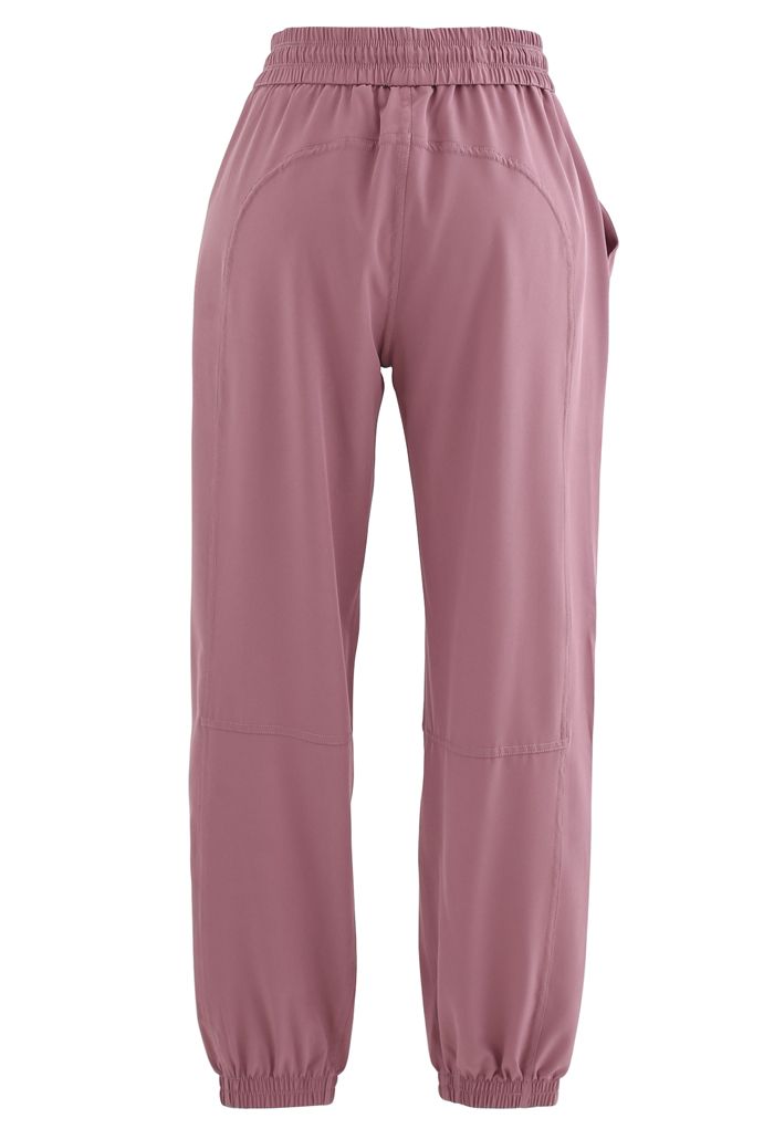 Joggers cónicos con bolsillos con cordón en rosa polvoriento