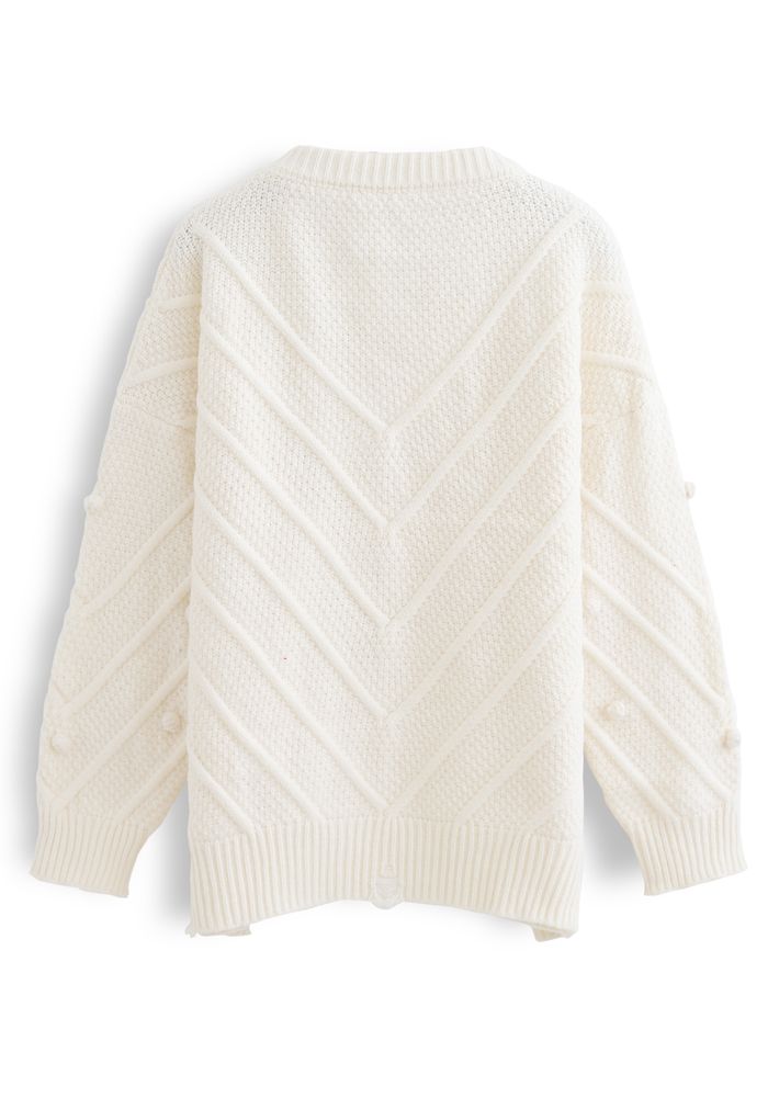 Suéter de punto extragrande con pompones y dobladillo sin rematar en color crema