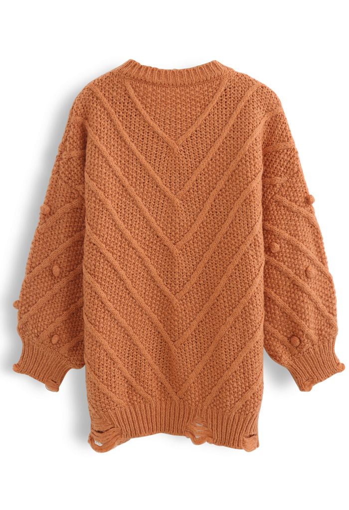 Suéter de punto extragrande con pompones y dobladillo sin rematar en naranja