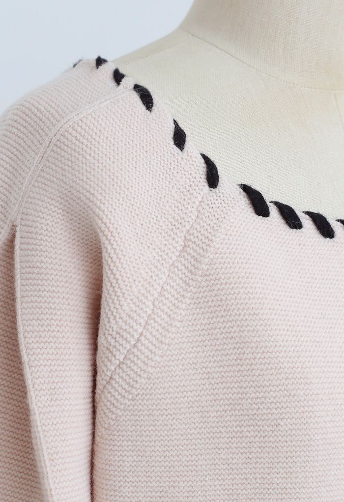 Suéter con mangas abullonadas y lazo con borde trenzado en rosa nude
