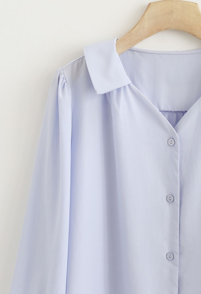 Camisa abotonada de manga tres cuartos en azul