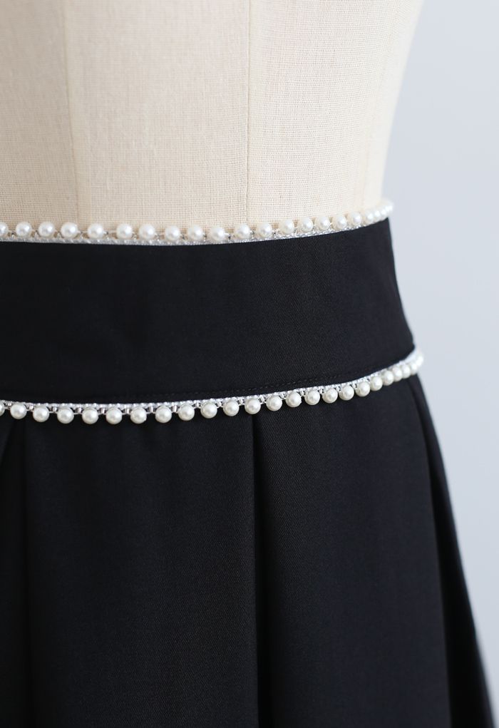 Falda midi plisada con cintura nacarada en negro