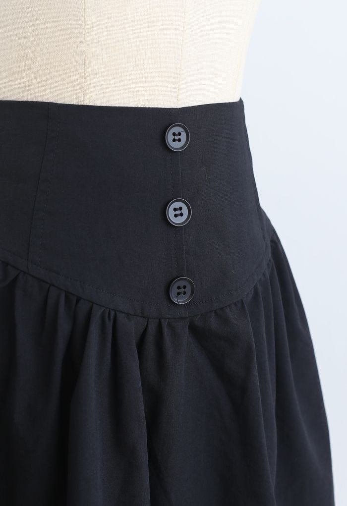 Minifalda de talle alto con ribete de botones en negro