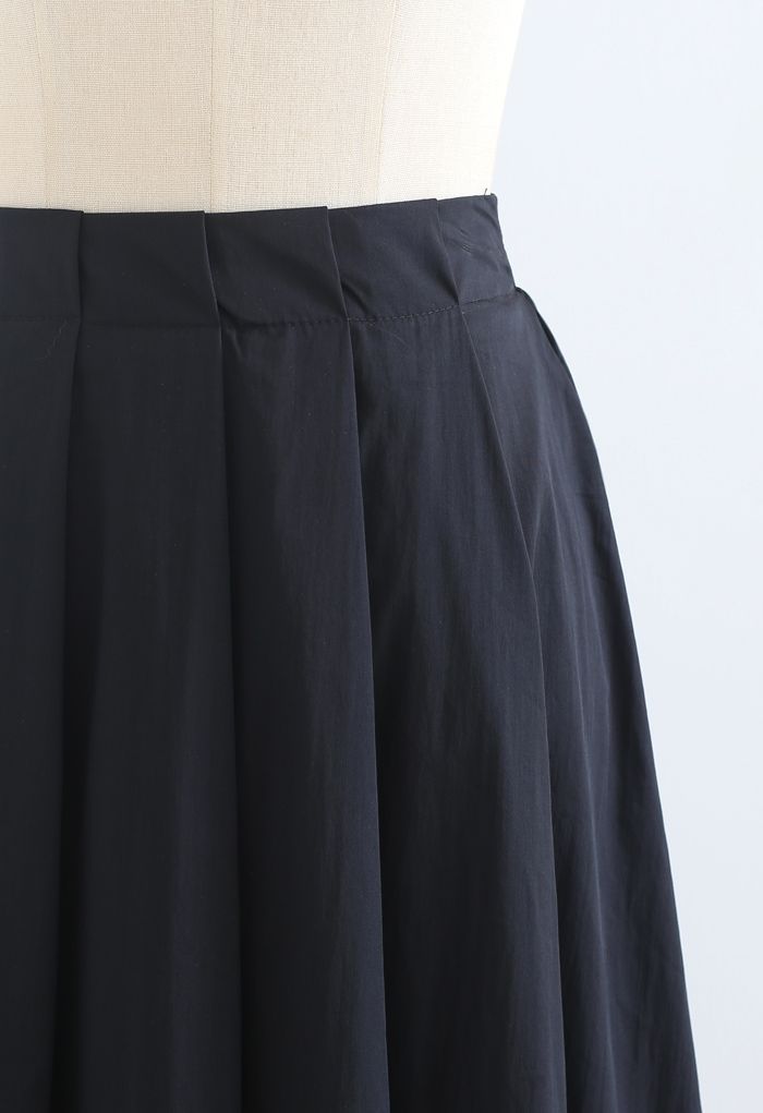 Falda midi plisada evasé de algodón en negro