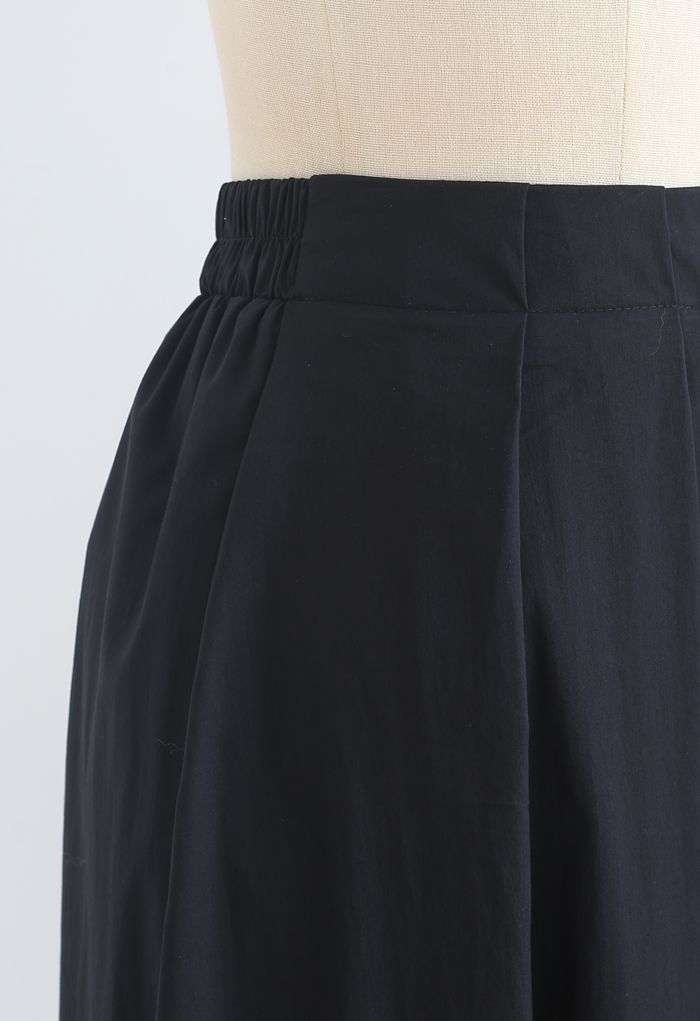 Falda midi plisada evasé de algodón en negro