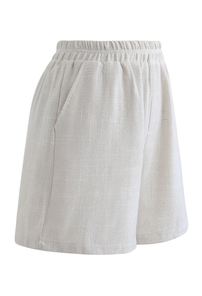 Pantalones cortos de lino y algodón con bolsillos en la cintura elástica en marfil