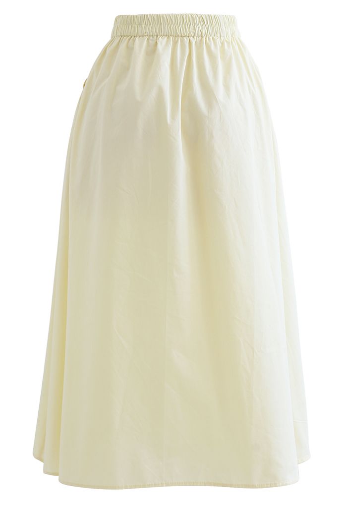 Falda de algodón con bolsillo lateral en color liso en amarillo claro