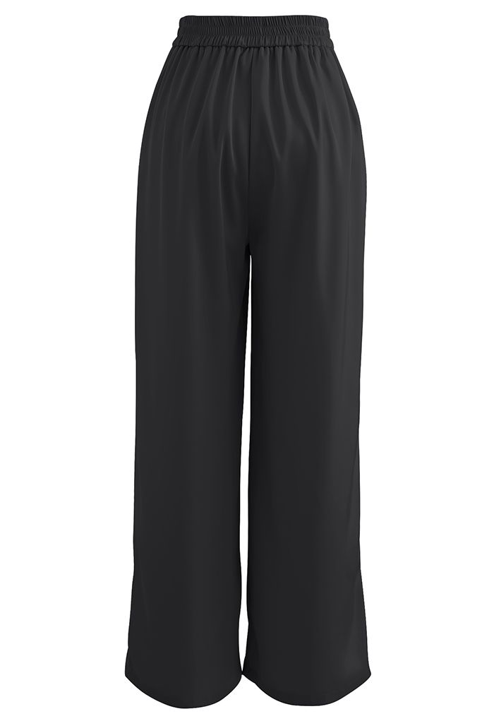 Pantalones de pierna ancha con pliegues brillantes en negro