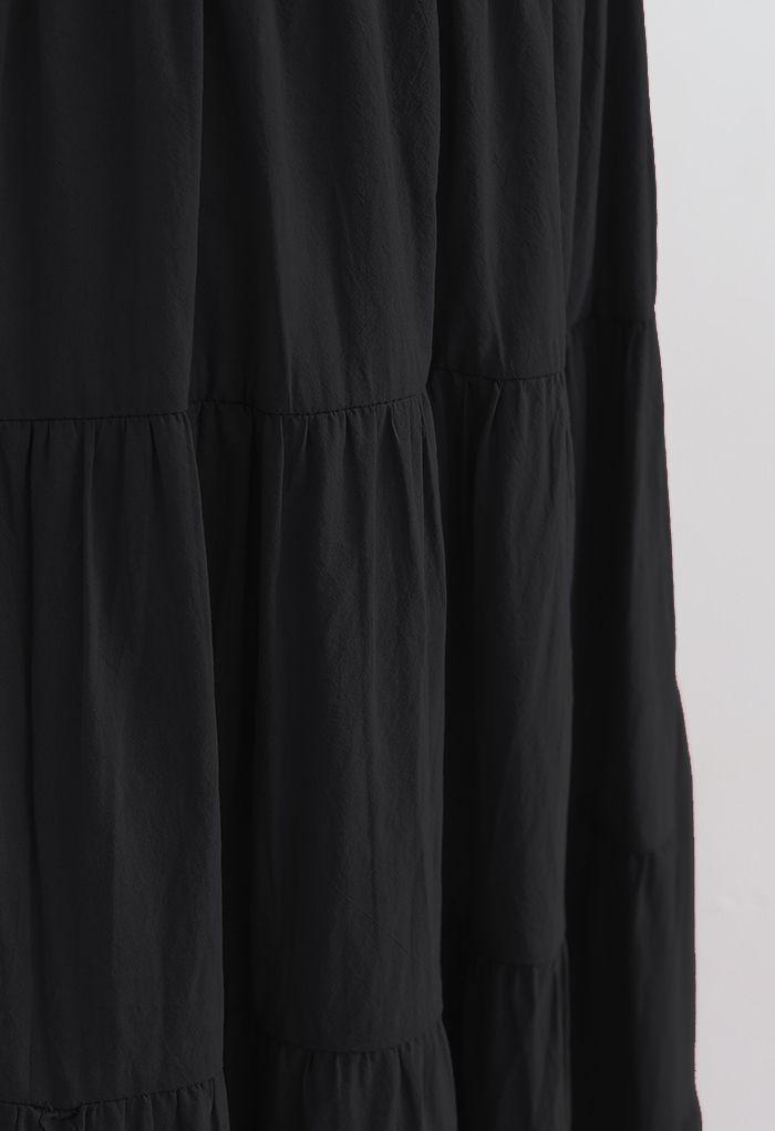 Falda midi de algodón con volantes en color liso en negro