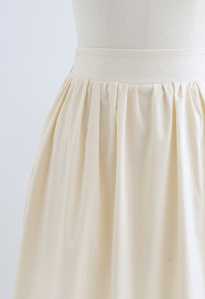Falda midi decorada con detalle de pliegues en color crema