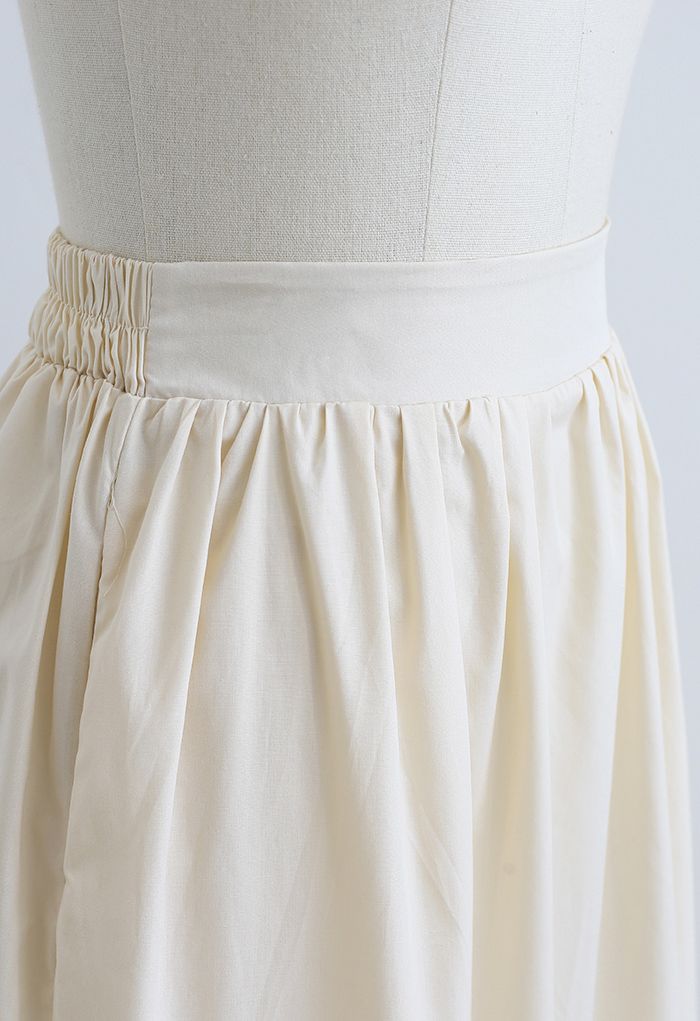 Falda midi decorada con detalle de pliegues en color crema