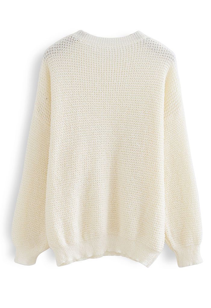 Suéter de punto extragrande con agujeros en color crema