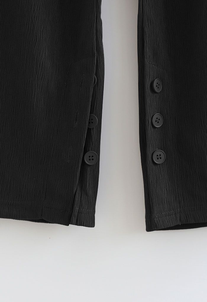 Pantalones de pierna recta con puños con abertura abotonada en negro