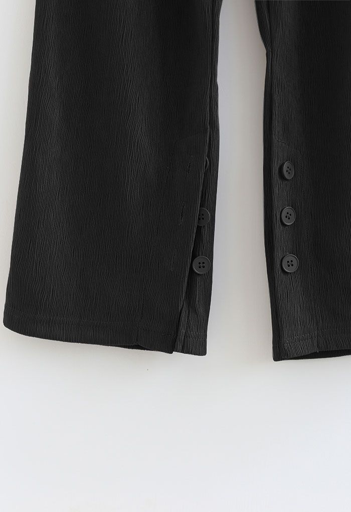 Pantalones de pierna recta con puños con abertura abotonada en negro