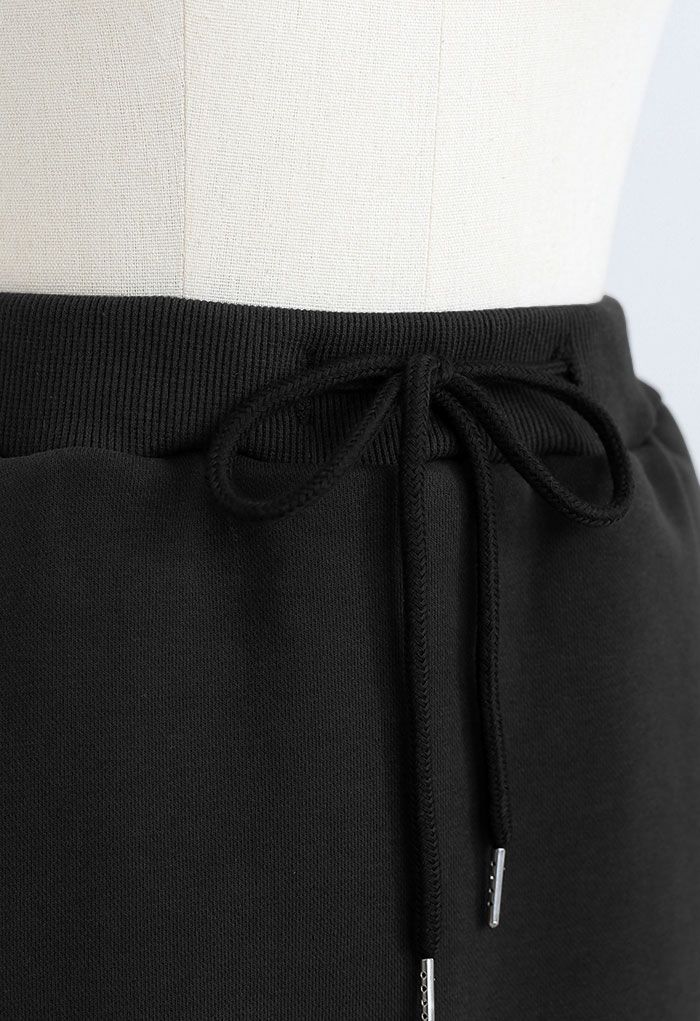 Minifalda pantalón de algodón con bolsillo con cordón en negro