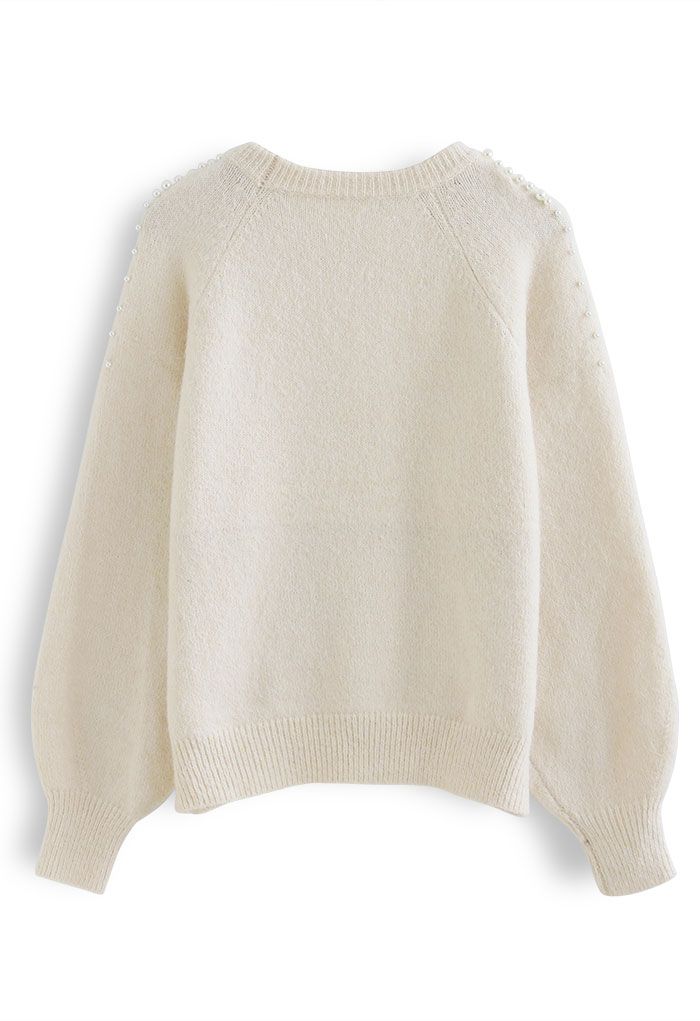 Suéter de punto difuso con hombros nacarados en crema