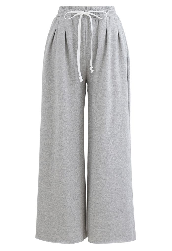 Pantalones recortados de pernera ancha y corte sin rematar con cordón en gris