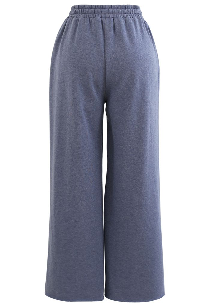 Pantalones recortados de pernera ancha y corte sin rematar con cordón en azul