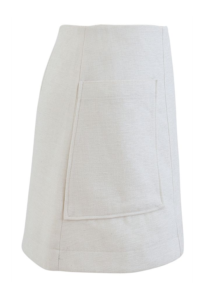 Minifalda de tweed brillante con bolsillo remendado en marfil