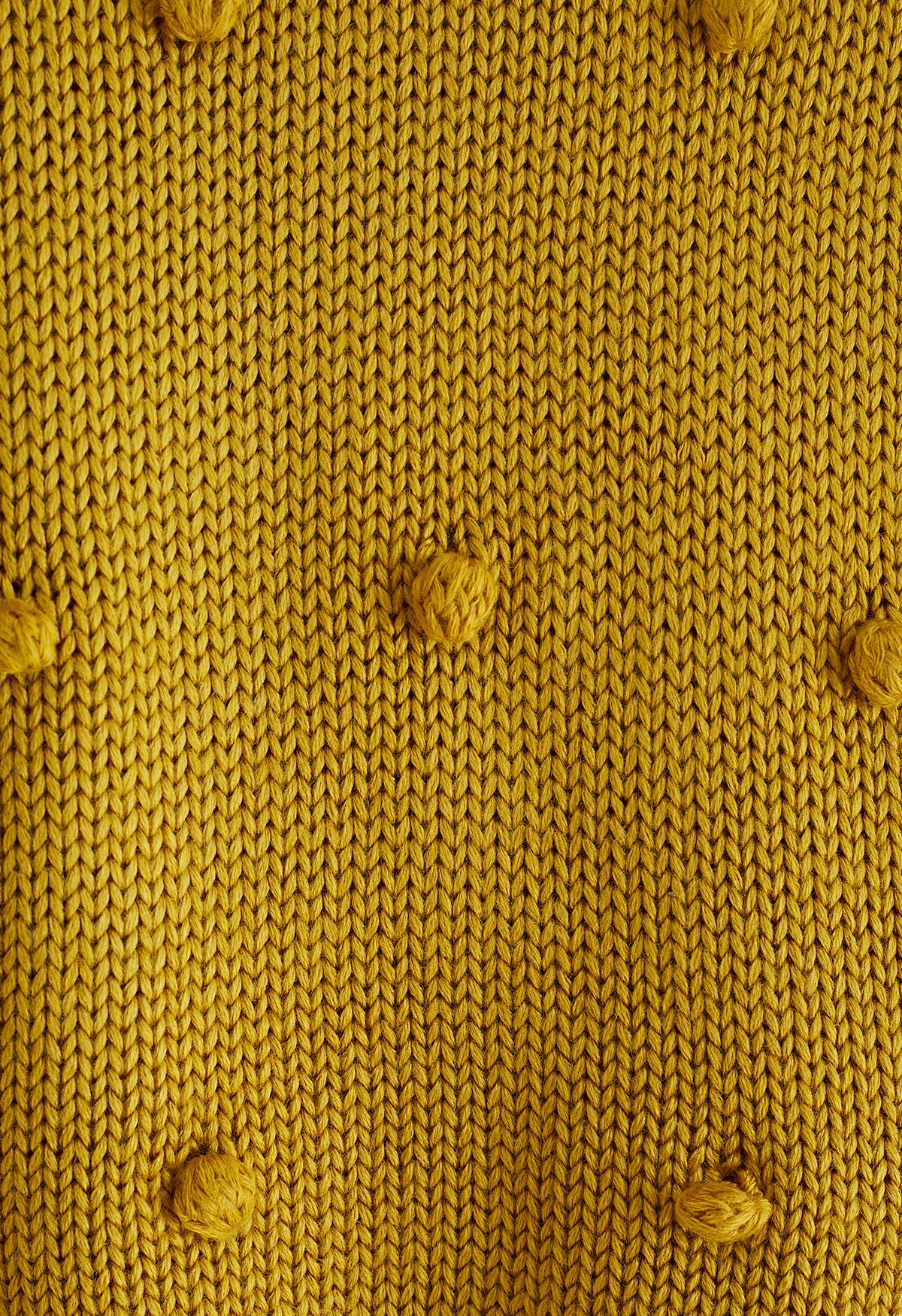 Jersey tejido a mano con pompones en mostaza para niños
