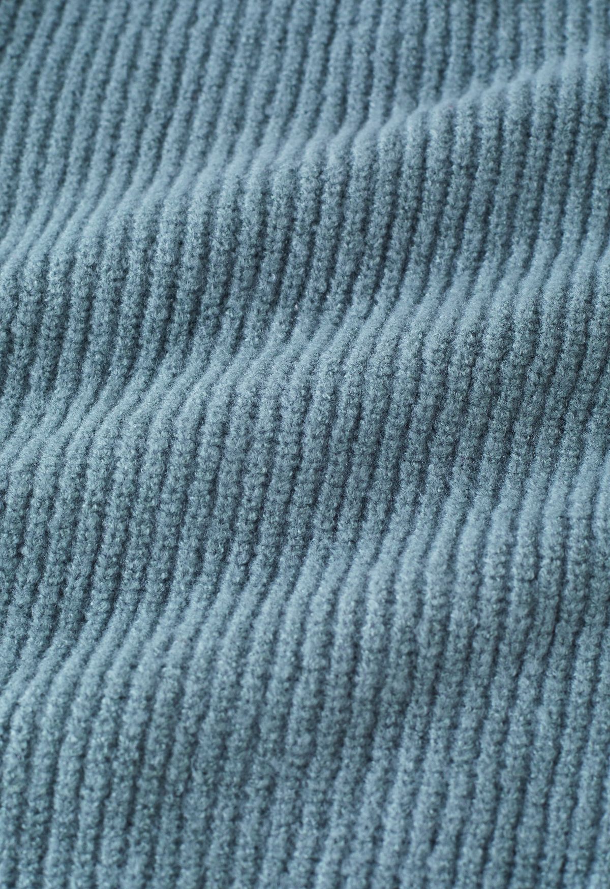 Suéter de punto con cuello redondo y nudo en azul polvoriento