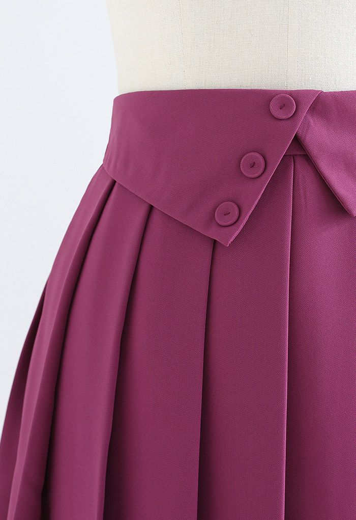 Minifalda plisada con cintura doblada y botones en magenta