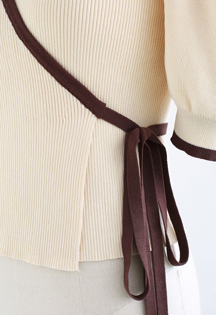 Top de punto cruzado con lazo en la cintura y mangas abullonadas en color crema