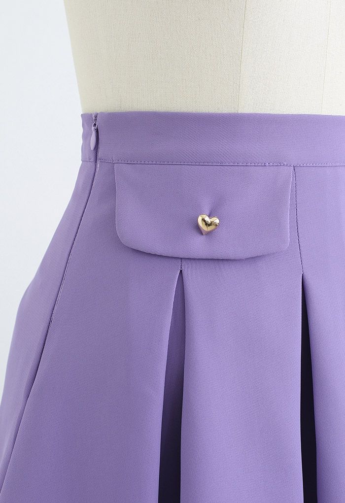 Minifalda plisada con botones de corazón pequeño en morado