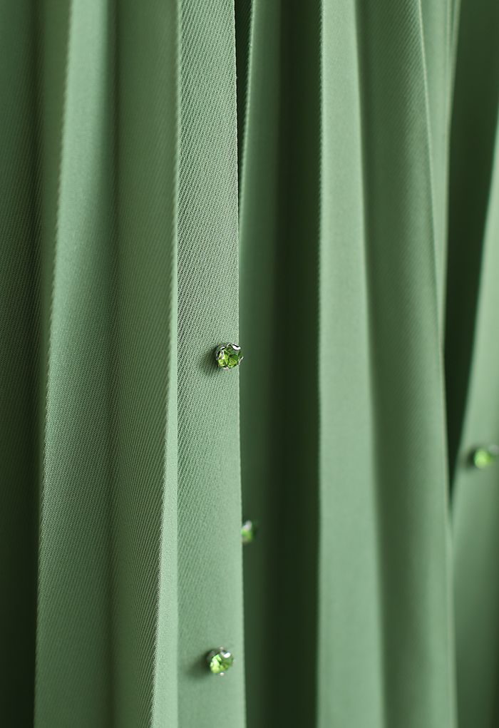 Falda midi plisada con gemas dispersas en verde