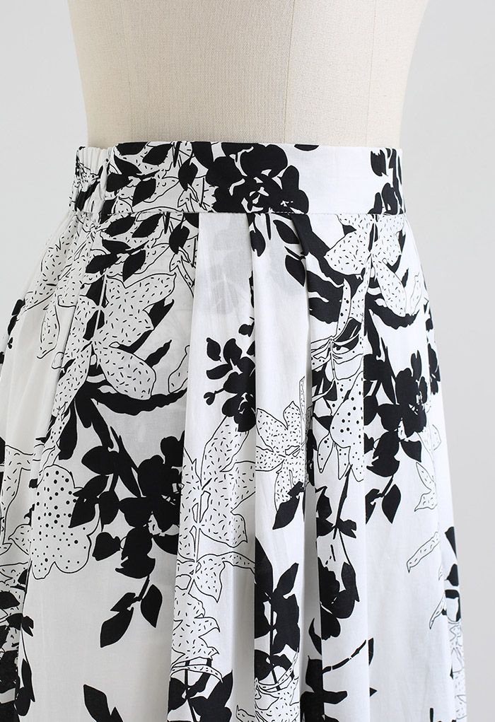 Falda midi de algodón con bolsillo lateral floral negra
