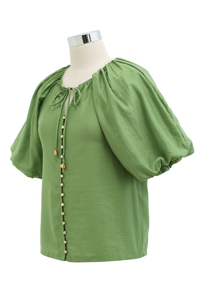 Top de manga de burbuja con botones en verde