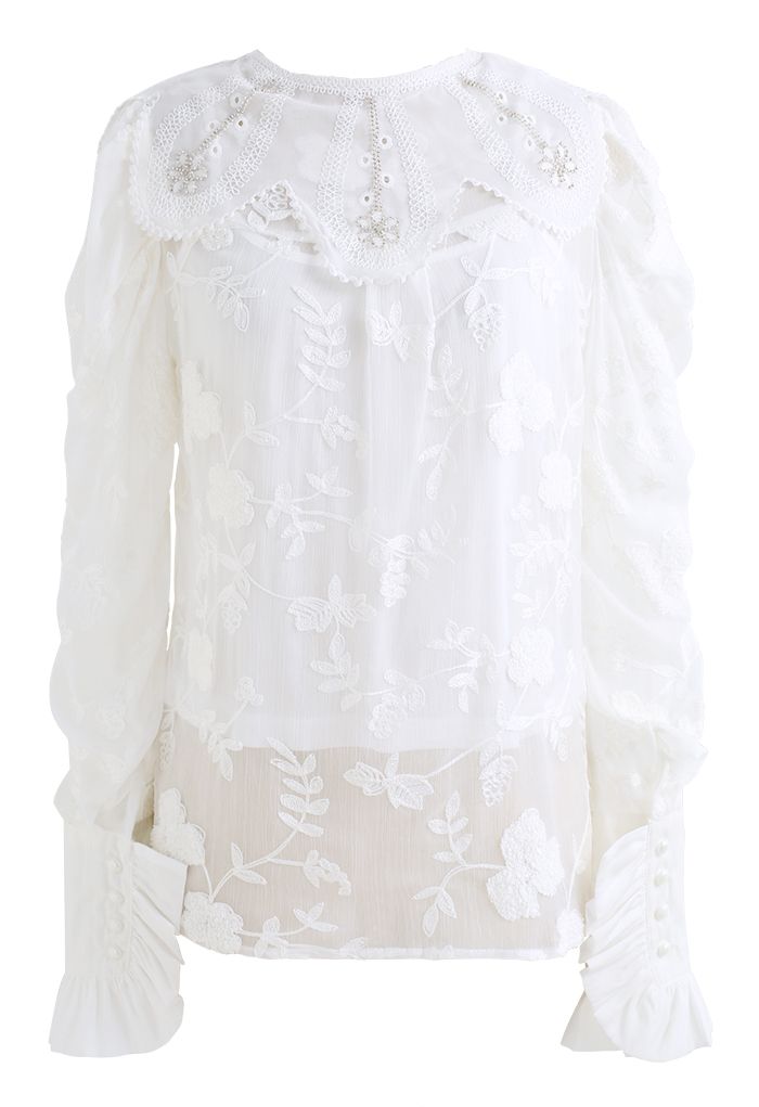 Camisa blanca con volantes bordados y cuello floral
