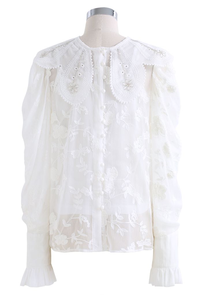 Camisa blanca con volantes bordados y cuello floral