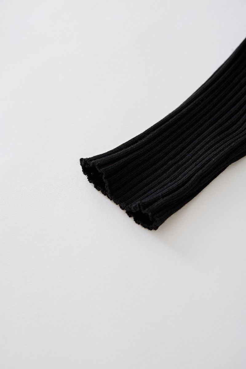 Conjunto de top de punto con cuello en V y falda plisada en negro