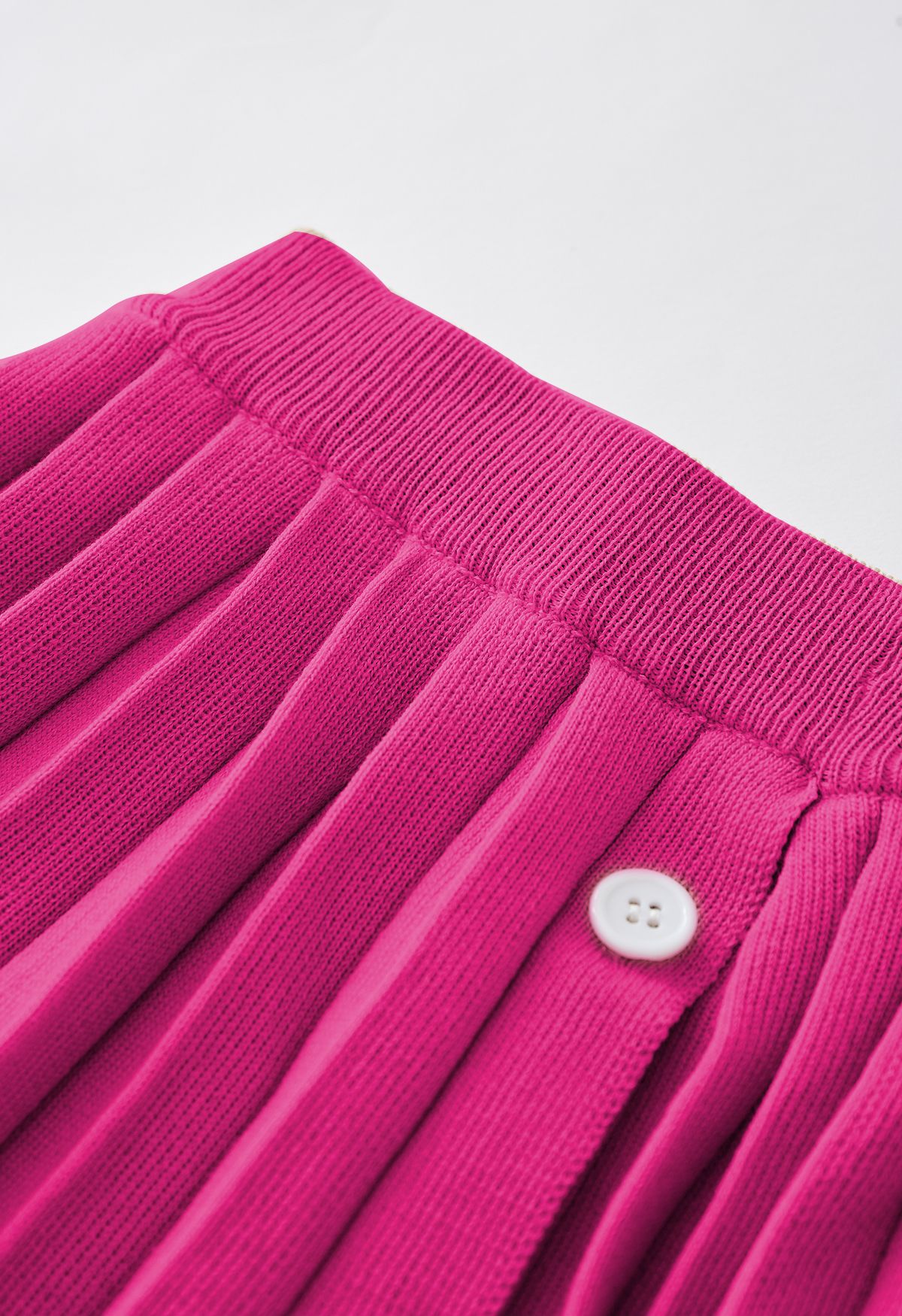 Conjunto de top de punto con cuello en V y falda plisada en rosa fuerte
