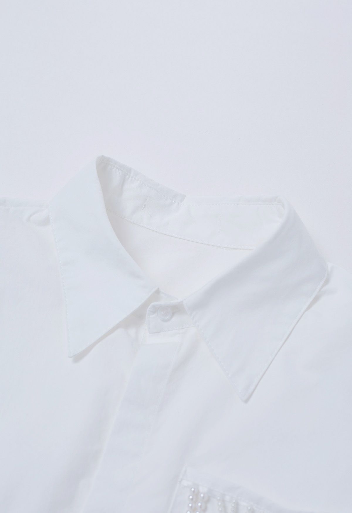 Camisa corta de algodón con cintura anudada y decoración de perlas
