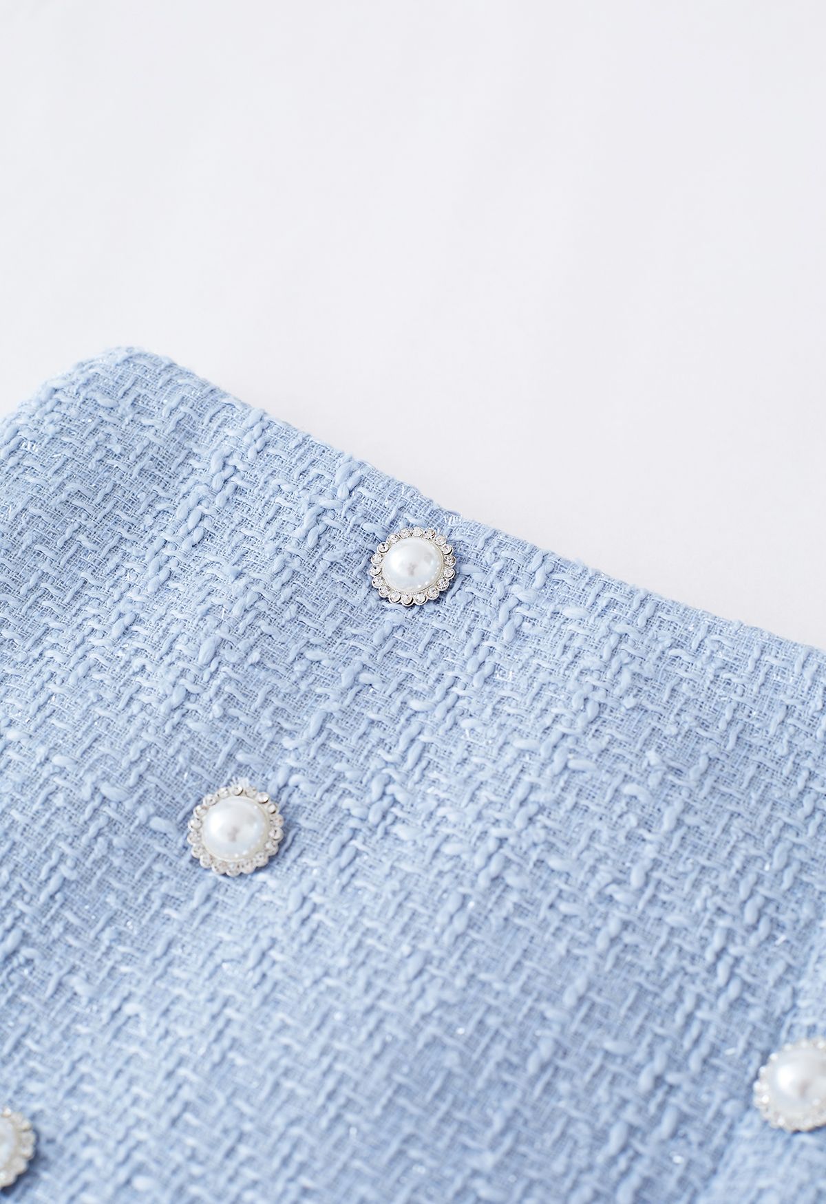 Minifalda de tweed plisada con doble botonadura en azul
