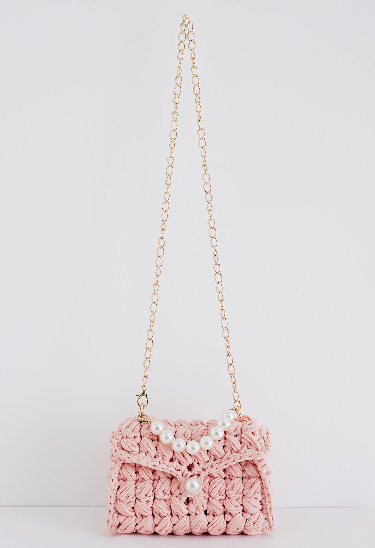 Minibolso de punto grueso trenzado con cadena de perlas en rosa
