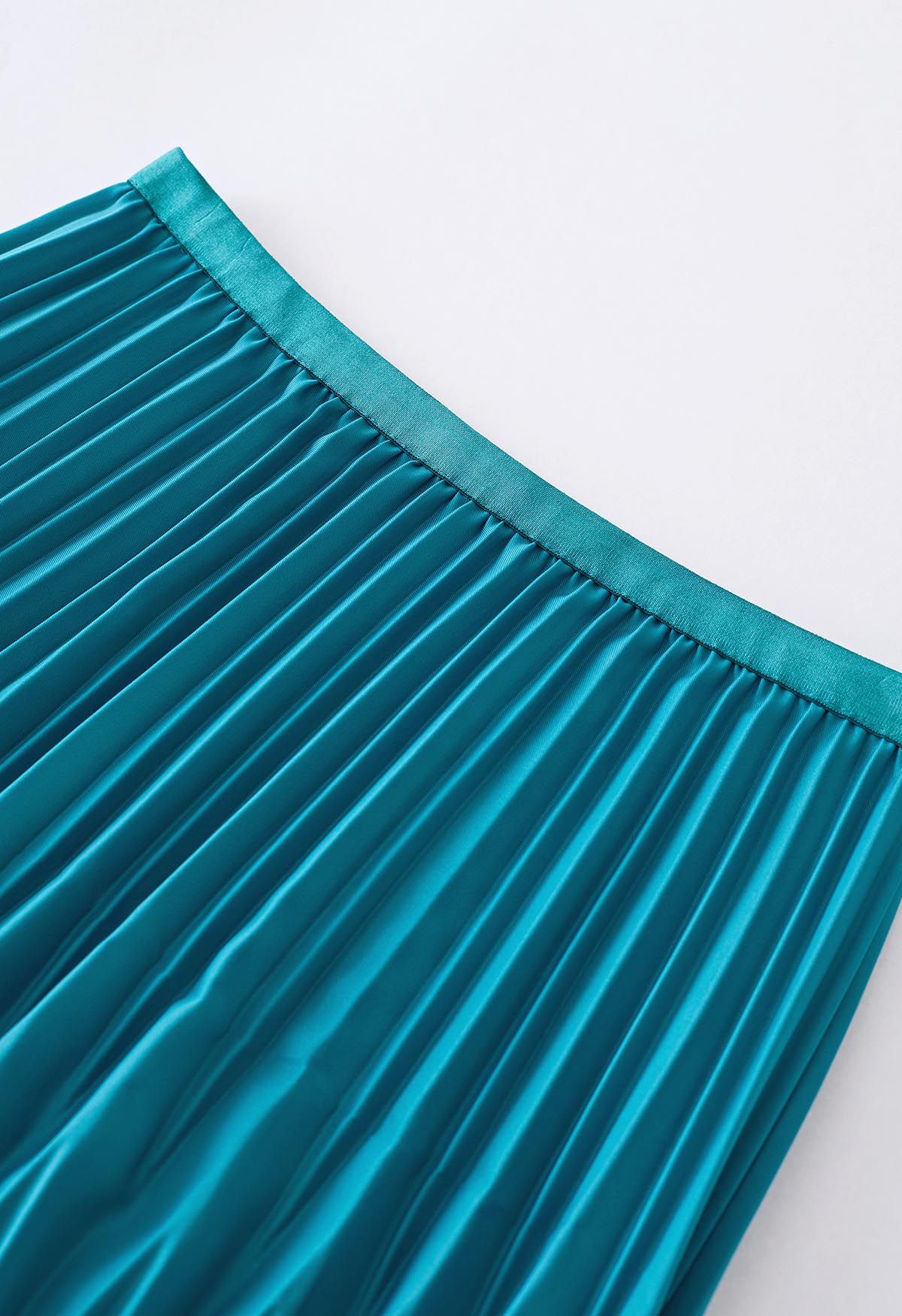 Falda midi plisada irregular en verde azulado