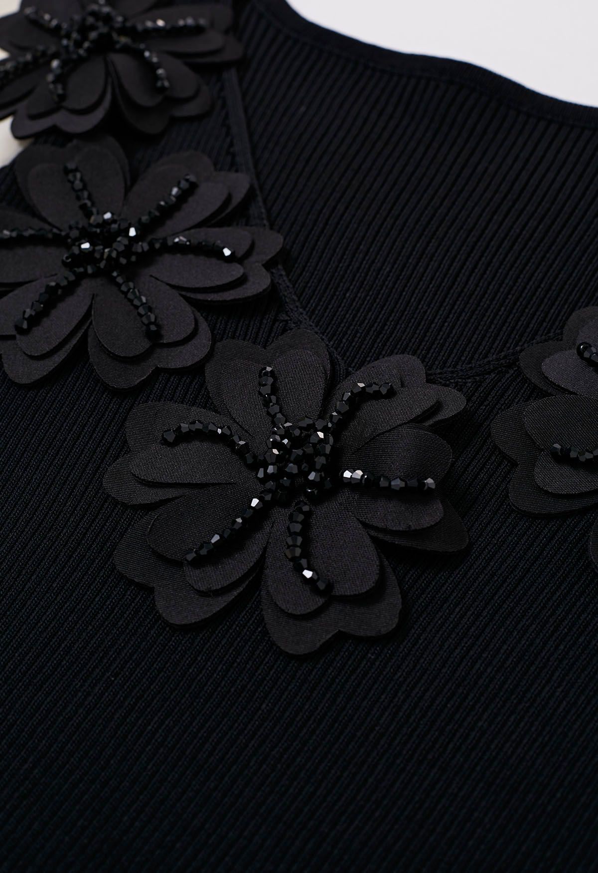 Top de punto empalmado con manga de burbuja y cuello en V con flores y cuentas en negro