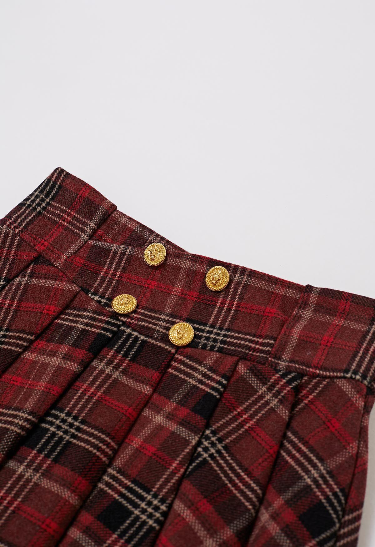 Minifalda plisada de mezcla de lana con botones dorados a cuadros burdeos