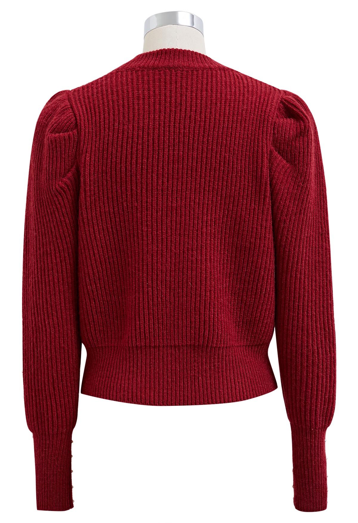 Suéter de punto con mangas abullonadas y adornos de perlas en rojo
