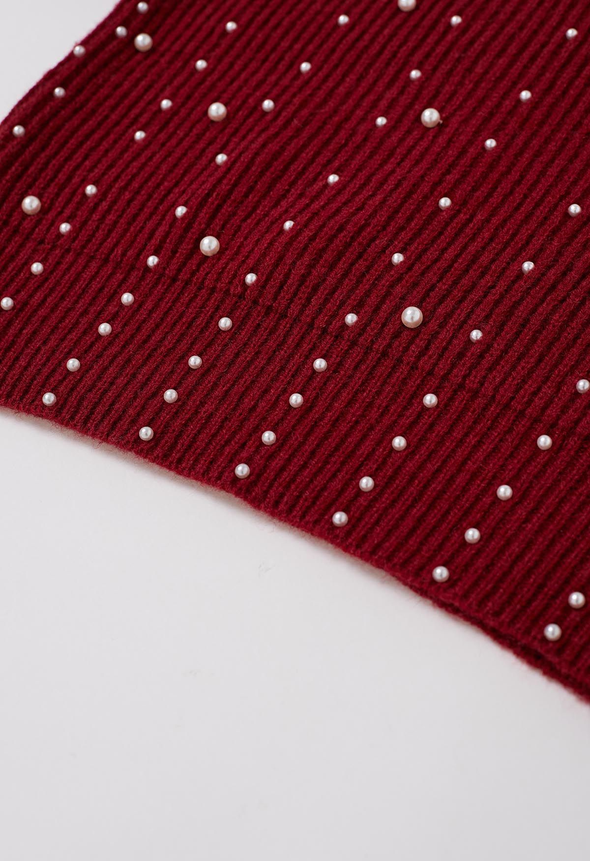 Suéter de punto con mangas abullonadas y adornos de perlas en rojo