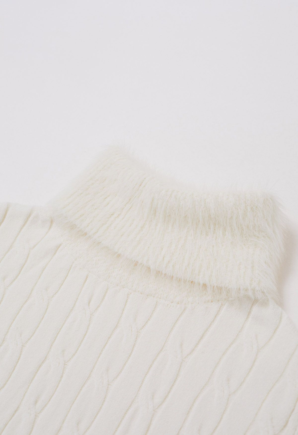 Suéter de punto de ochos con cuello alto suave y difuso en color crema