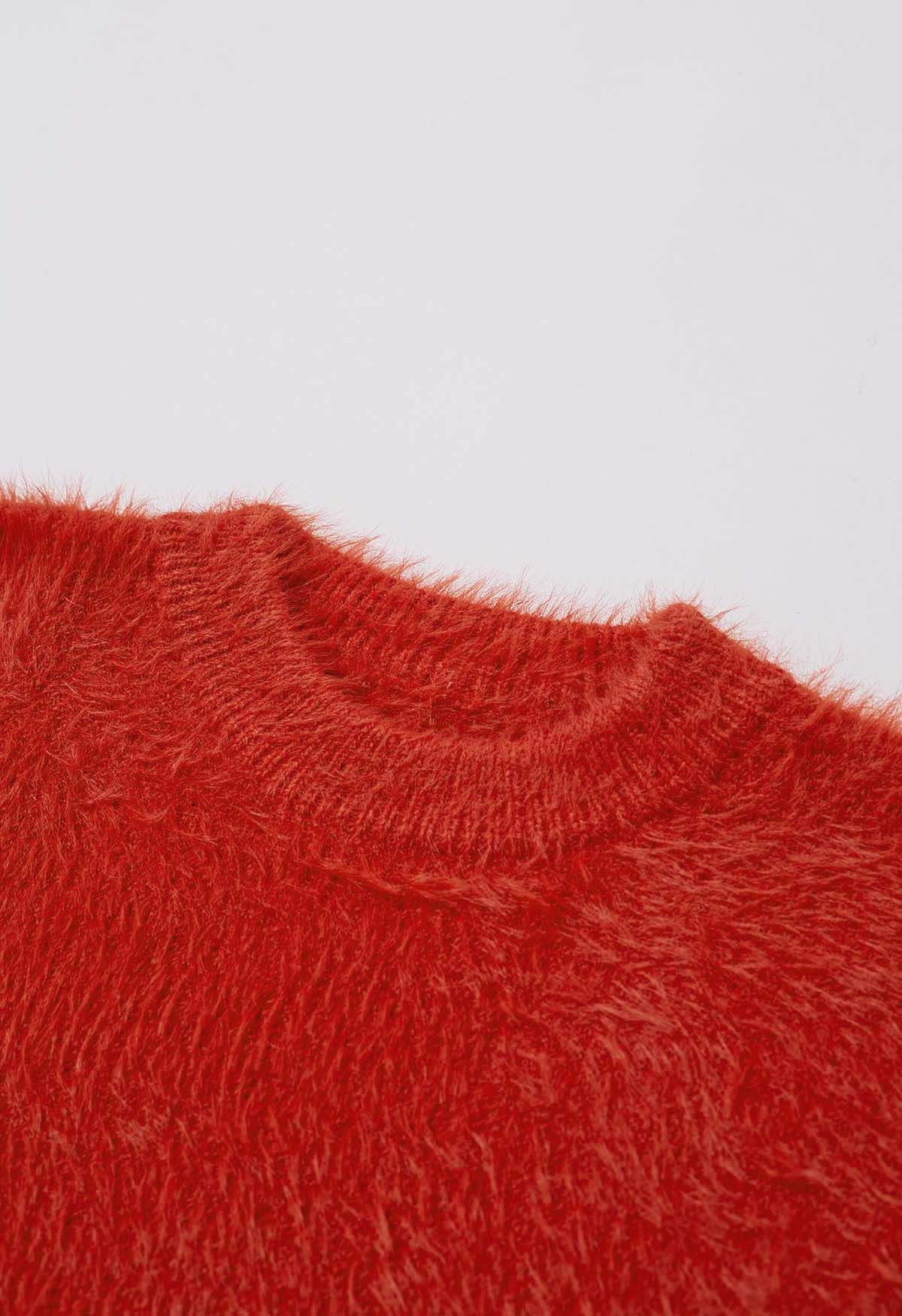 Suéter de punto borroso de color liso en naranja